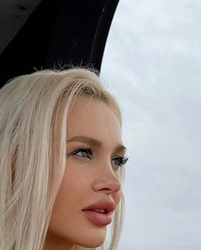 Bimbo photo posing: chin forward and down, camera above the eye line, shoulders turned away.