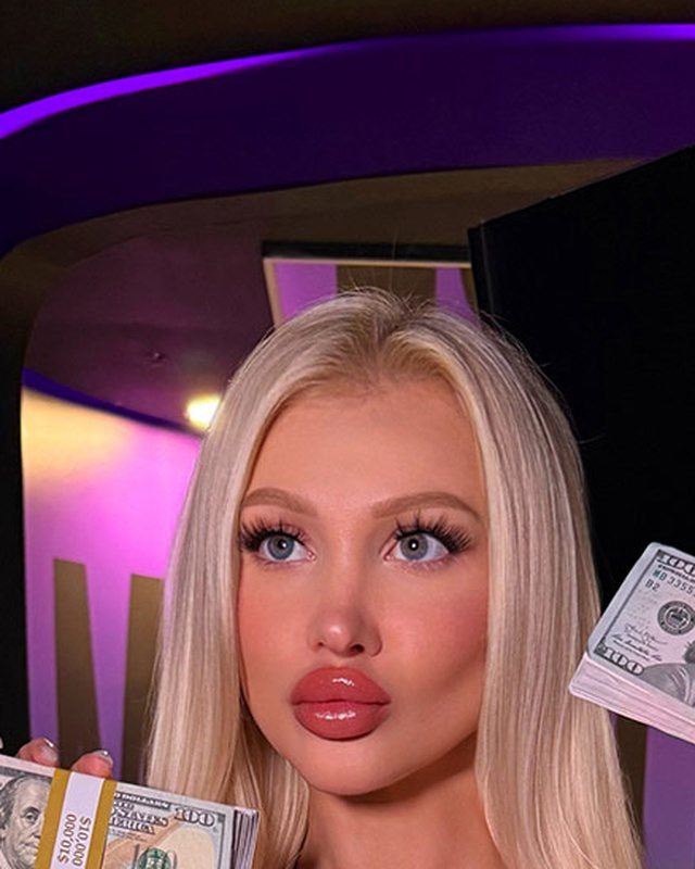 Long platinum blonde bimbo hair extensions, cool-toned and straight with a centre part.